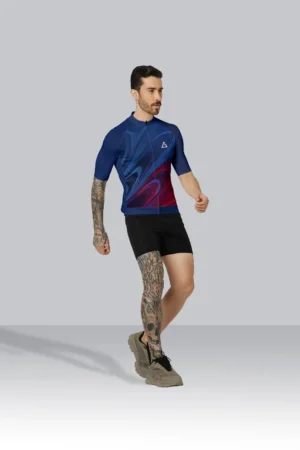 Cyclist wearing the Aidan Global Aero Surge Race Fit Cycling Jersey in a deep blue-to-red gradient design, built for speed and comfort